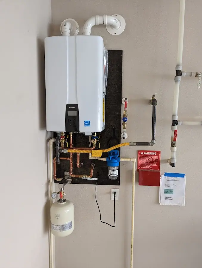 Professional plumber installing copper piping in a Seven Oaks home